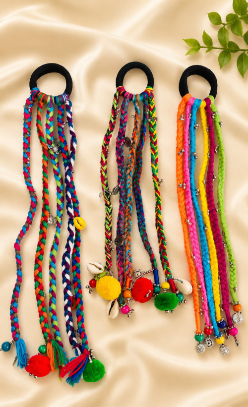 Boho braided parandi hair tie in rainbow multicolor braided cords with pom-poms, beads, and cowrie shells