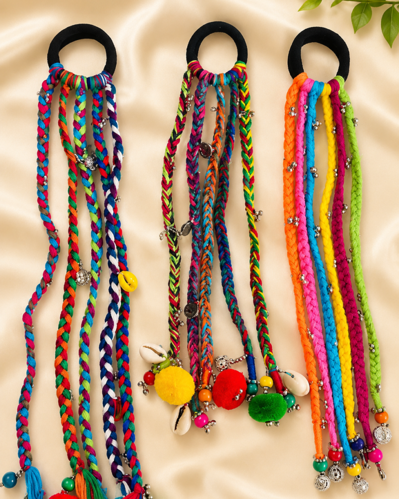 Boho braided parandi hair tie in rainbow multicolor braided cords with pom-poms, beads, and cowrie shells