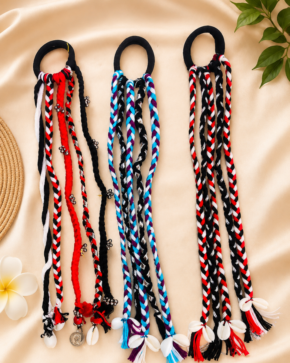 Boho braided parandi hair tie in black, red, white, and blue braided cords with cowrie shell and bead accents