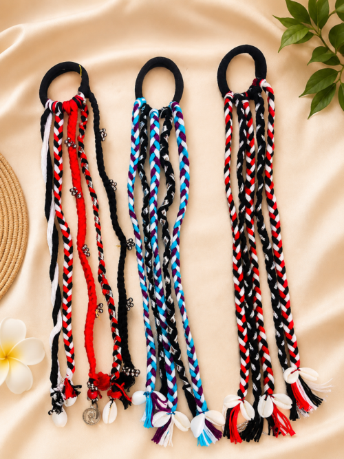 Boho braided parandi hair tie in black, red, white, and blue braided cords with cowrie shell and bead accents