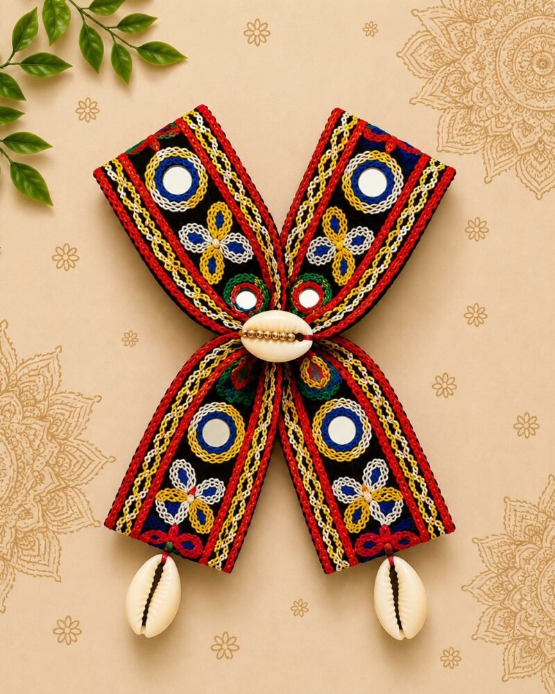 Handmade black mirror-work embroidered hair bow with cowrie shell tassels