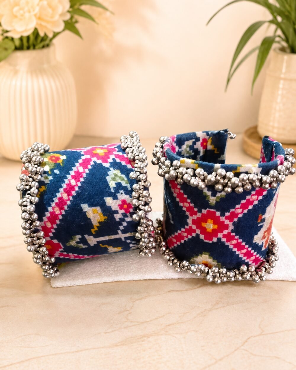 Navy ikat print fabric cuffs with dense silver ghungroo bell trim