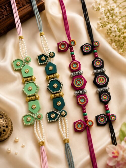 Pearl tassel necklaces styled on silk with brass urli and jasmine