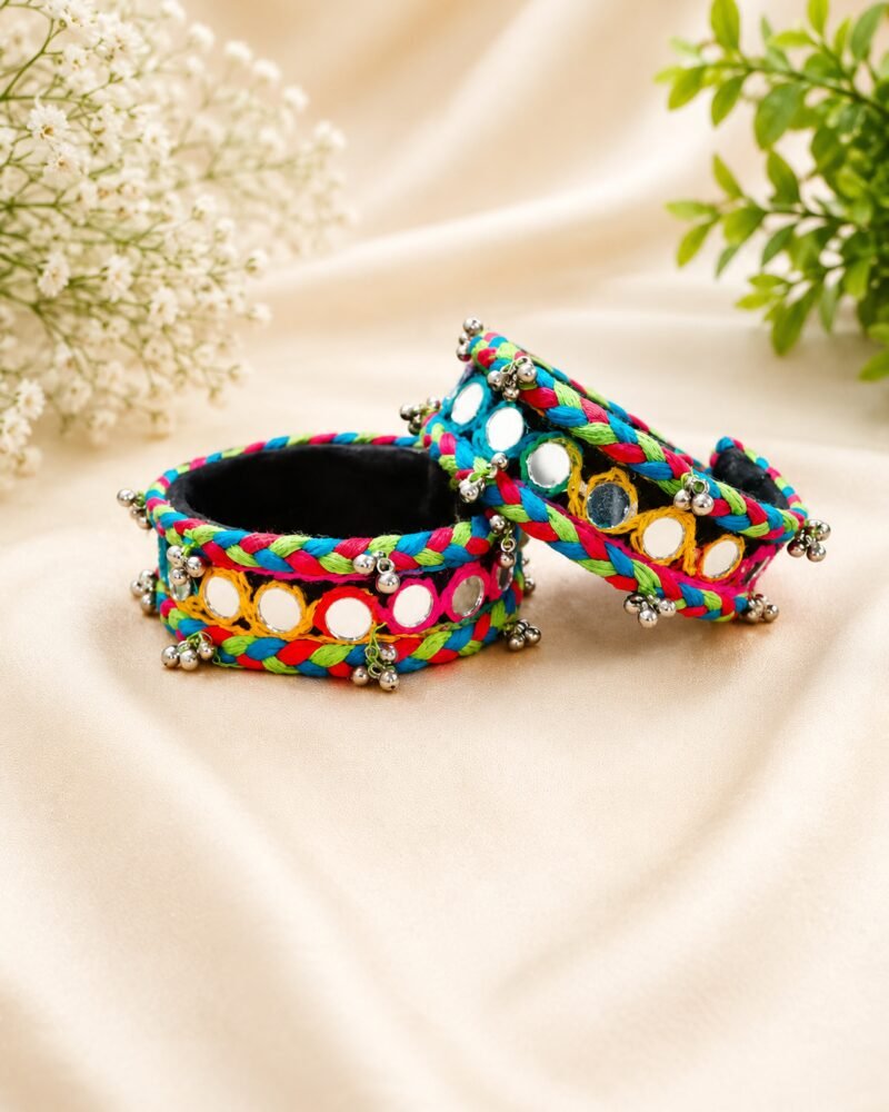 Braided multicolour thread cuffs with round mirror work and silver bell trim