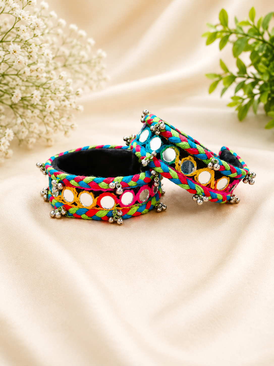 Braided multicolour thread cuffs with round mirror work and silver bell trim