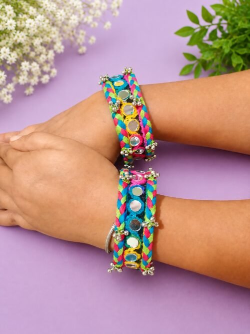 Rainbow braided mirror-work cuffs worn on model