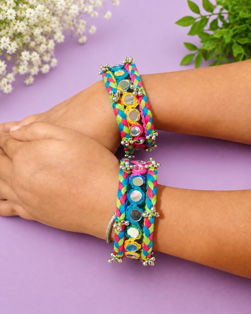 Rainbow braided mirror-work cuffs worn on model