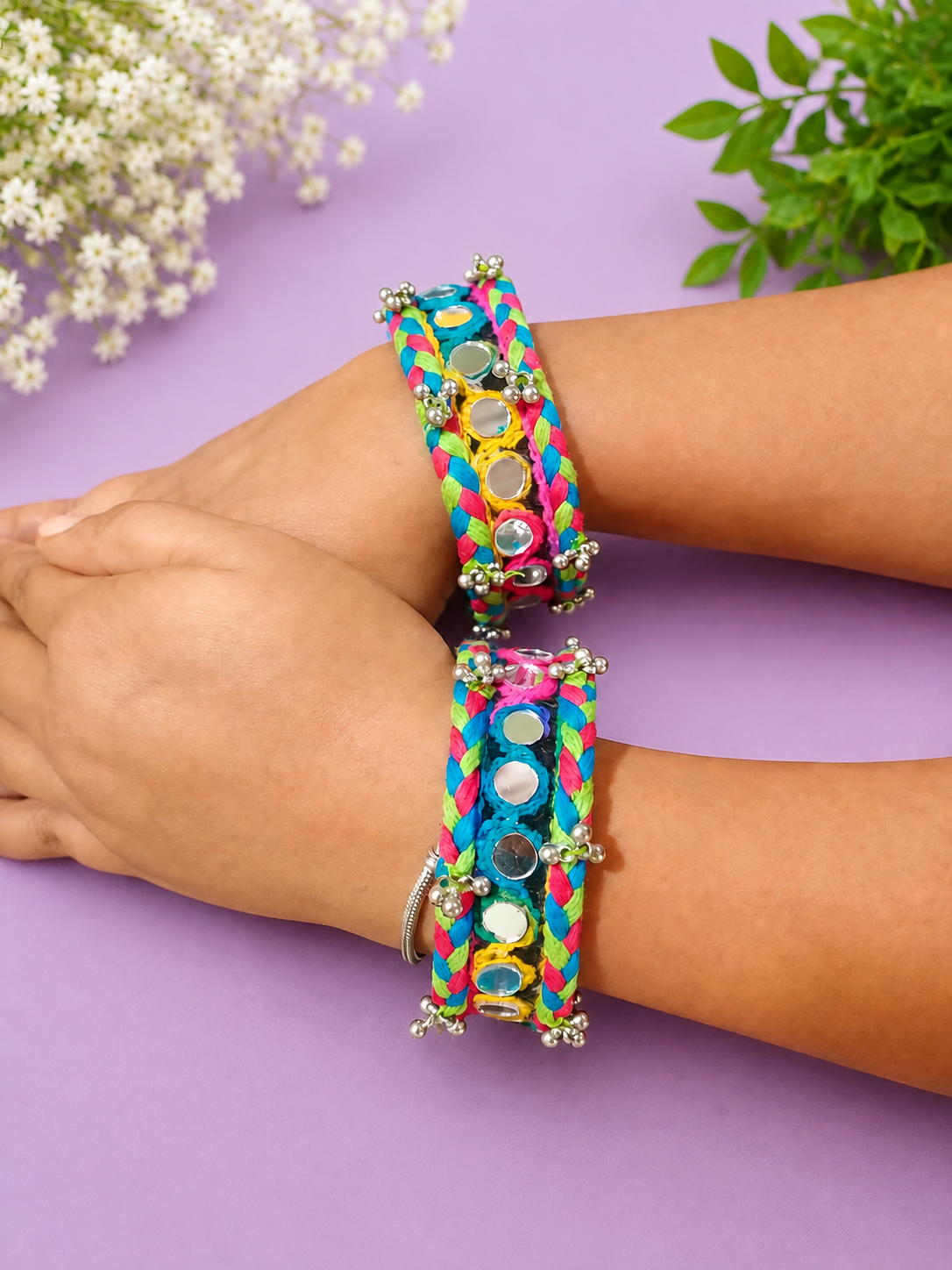 Rainbow braided mirror-work cuffs worn on model
